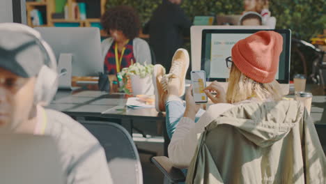 casual office workers reviewing data on smartphones