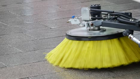 street sweeper cleaning cobblestone pavement