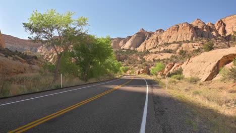 view of scenic byway 24 in utah through capitol reef national park on a sunny day