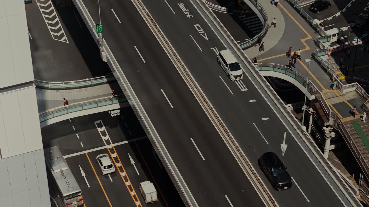 Aerial view of a highway with cars and pedestrians
