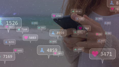 animación de iconos de redes sociales con números sobre mujer caucásica usando teléfono inteligente.