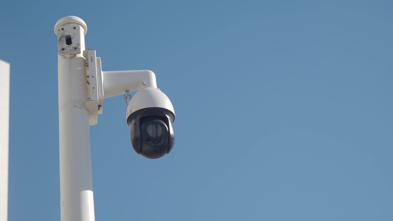 CCTV Security Camera on Pole Against Blue Sky