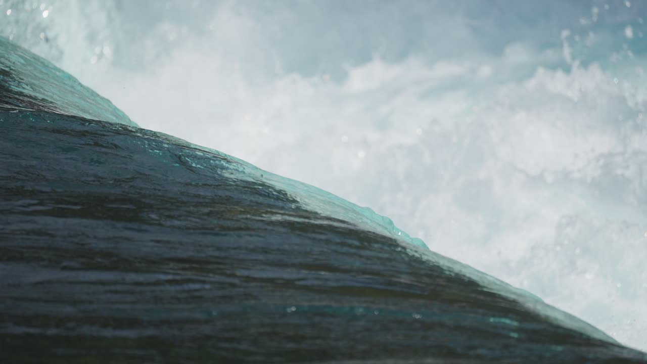 Transparent crystal-clean water flows and falls, and foam rises above