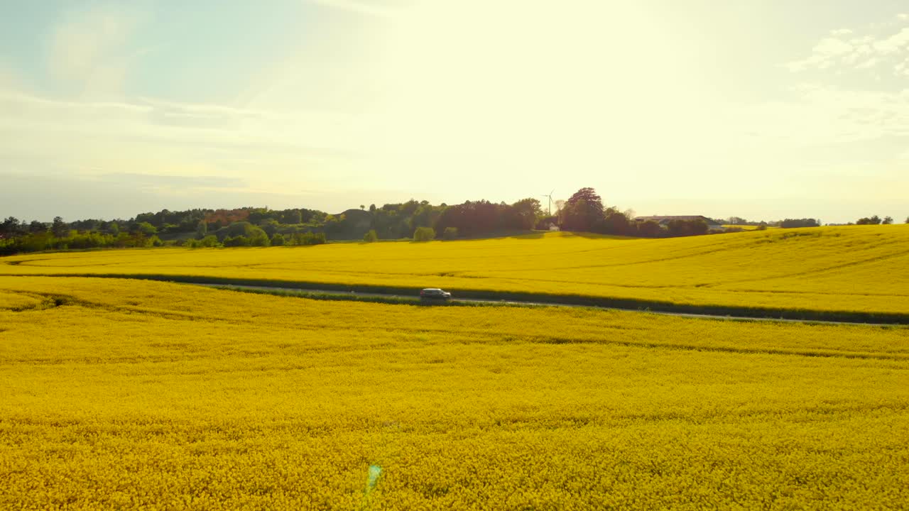 Car driving through beautiful landscape on a summer day