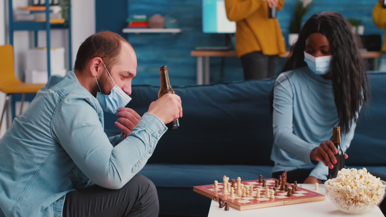 Mixed races of friends moving pieces on the chessboard