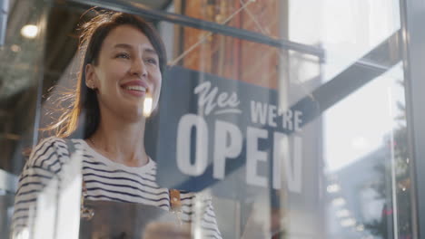 business owner hanging open/closed sign