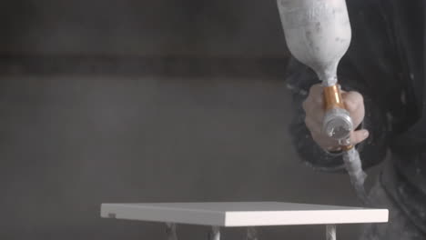 spray painting furniture in a workshop