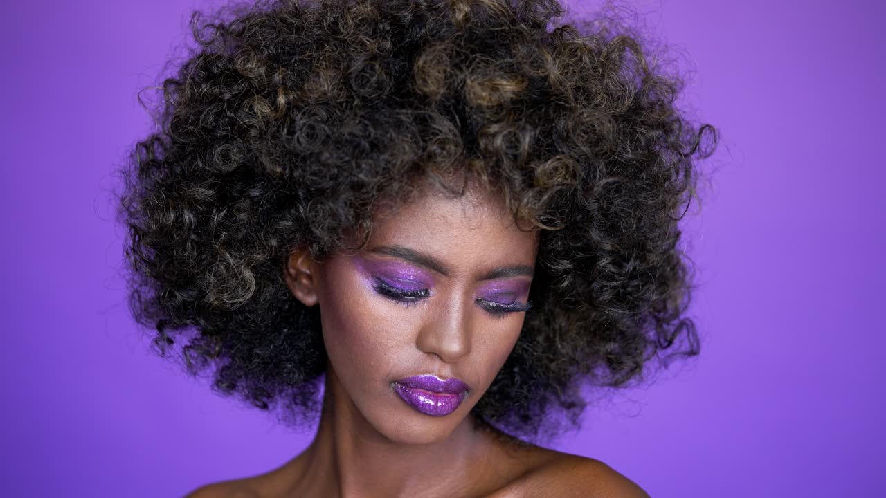 mujer con maquillaje púrpura y afro