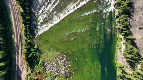 aerial topdown of kootenai falls flowing on the kootenai river with lush greenery in libby, montana, usa