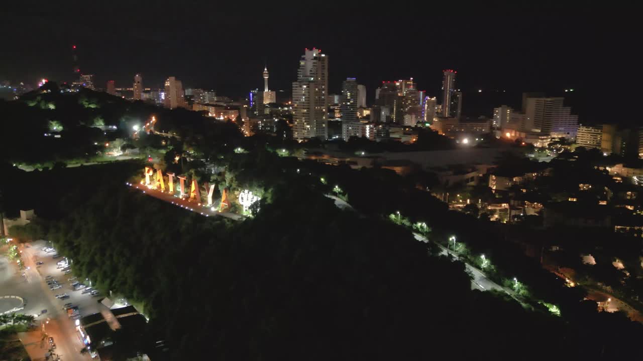 Aerial Fly Pattaya City at night, Thailand's travel beach natural illuminated, establishing shot