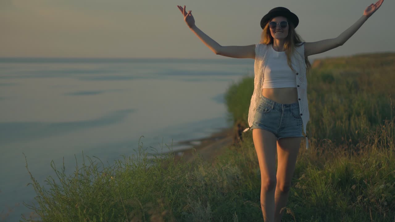 Woman enjoying a sunset walk along a riverbank