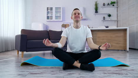 healthy lifestyle man doing yoga on quarantine. young fit man in sportswear working out at home.