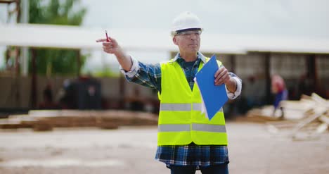 Engineer Explaining While Holding Blueprint 8