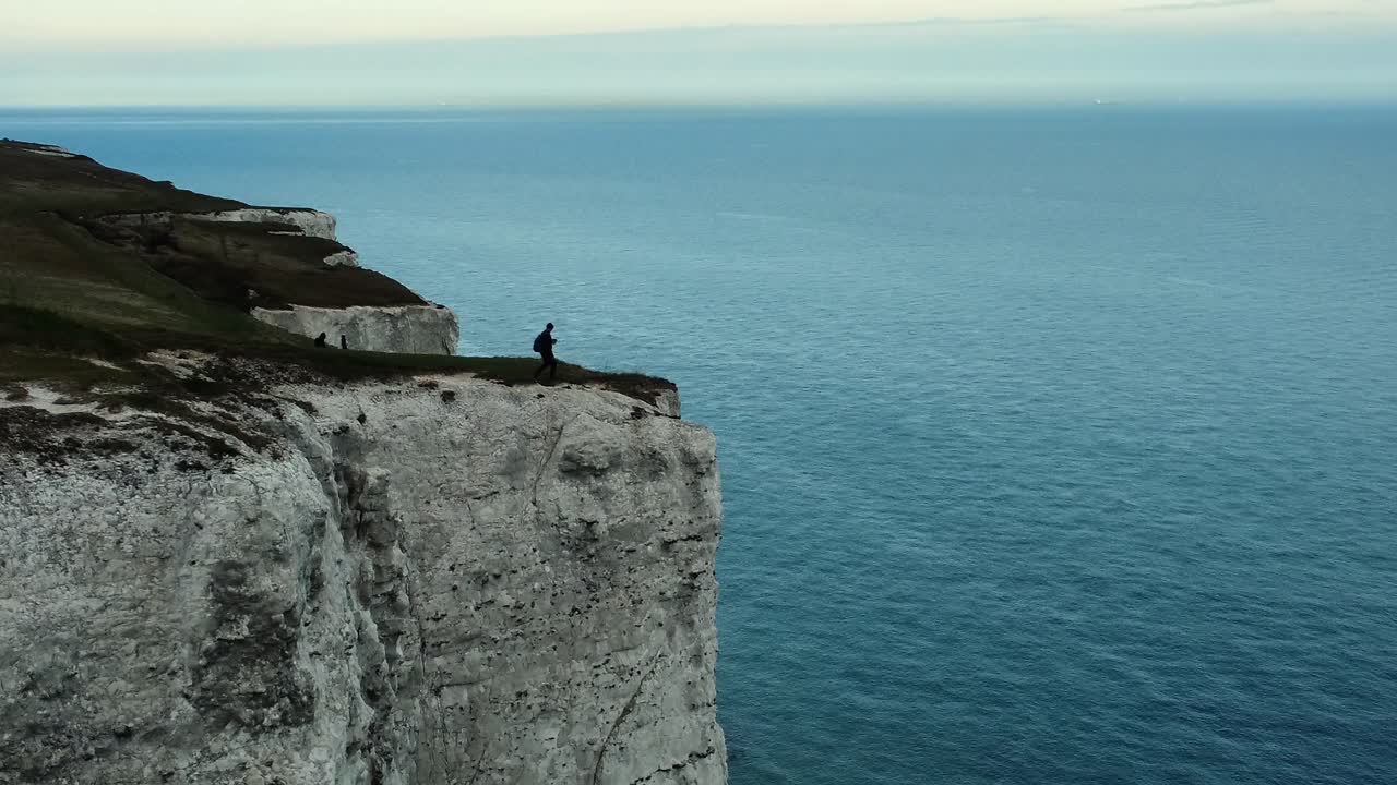 Man on a Cliff Overlooking the Sea