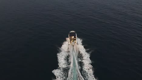 A-speedboat-speeds-across-the-Adriatic-sea-near-Dubrovnik,-Croatia---Aerial
