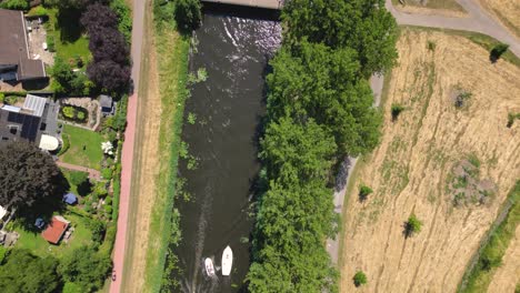 birds-eye-view-of-a-nature-park,-water-canal-with-boats,-of-Almere-city,-province-Flevoland,-Netherlands