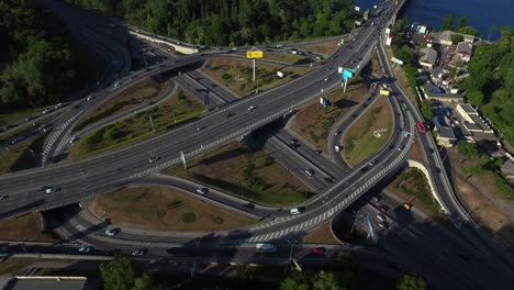 highway intersection on river landscape. aerial view car driving on freeway