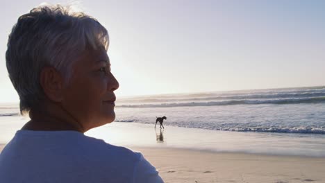 senior african american woman walking at the beach