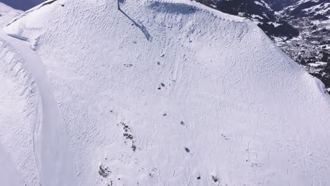 stunning drone footage high over a ski run in the swiss alps
