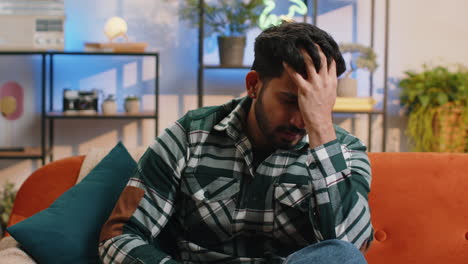 upset indian man making face palm gesture feeling bored disappointed in fail bad results news
