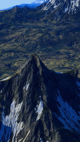 majestic mountain peak rises above lush green valley landscape