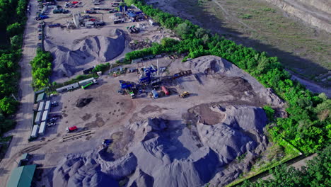 opencast granite mining quarry with working machinery