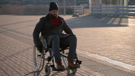 disabled man in wheelchair on city street