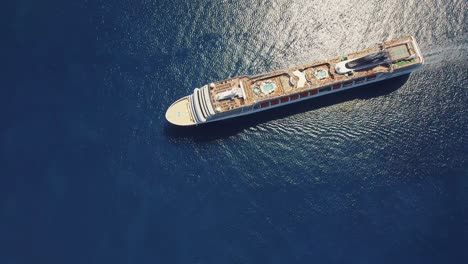 stunning top down shot in 4k of cruise ship msc orchestra in calm blue water - 4k drone footage - amazing view in uhd - mediterranean sea