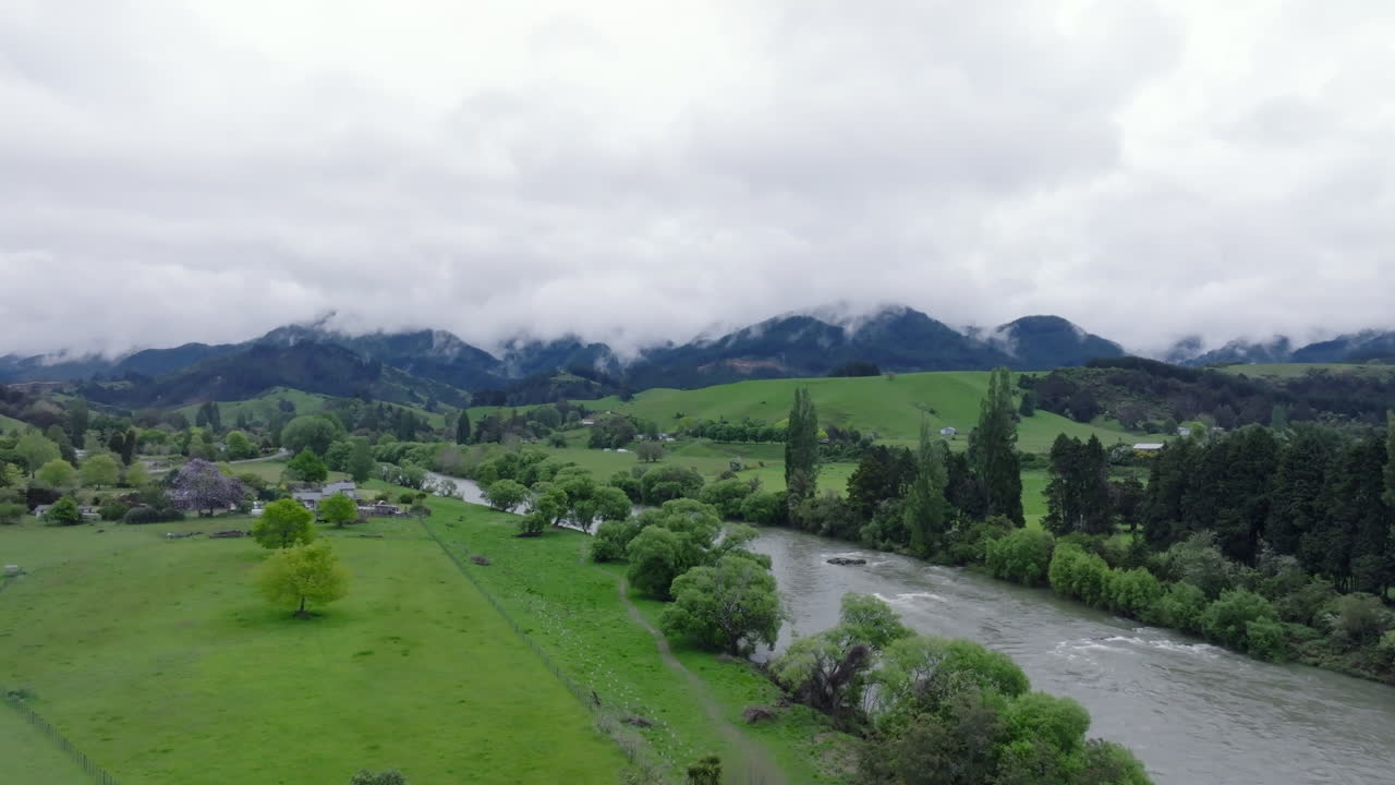 Aerial drone shot circling the Motueka river on an overcast wet day, New Zealand