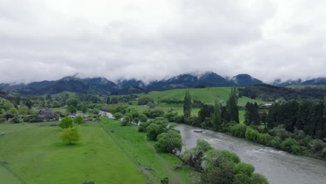 aerial drone shot circling the motueka river on an overcast wet day, new zealand