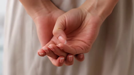 woman's hands clasped behind her back
