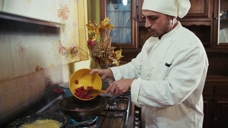 private chef at home cooking italian tomatoes in the professional pan