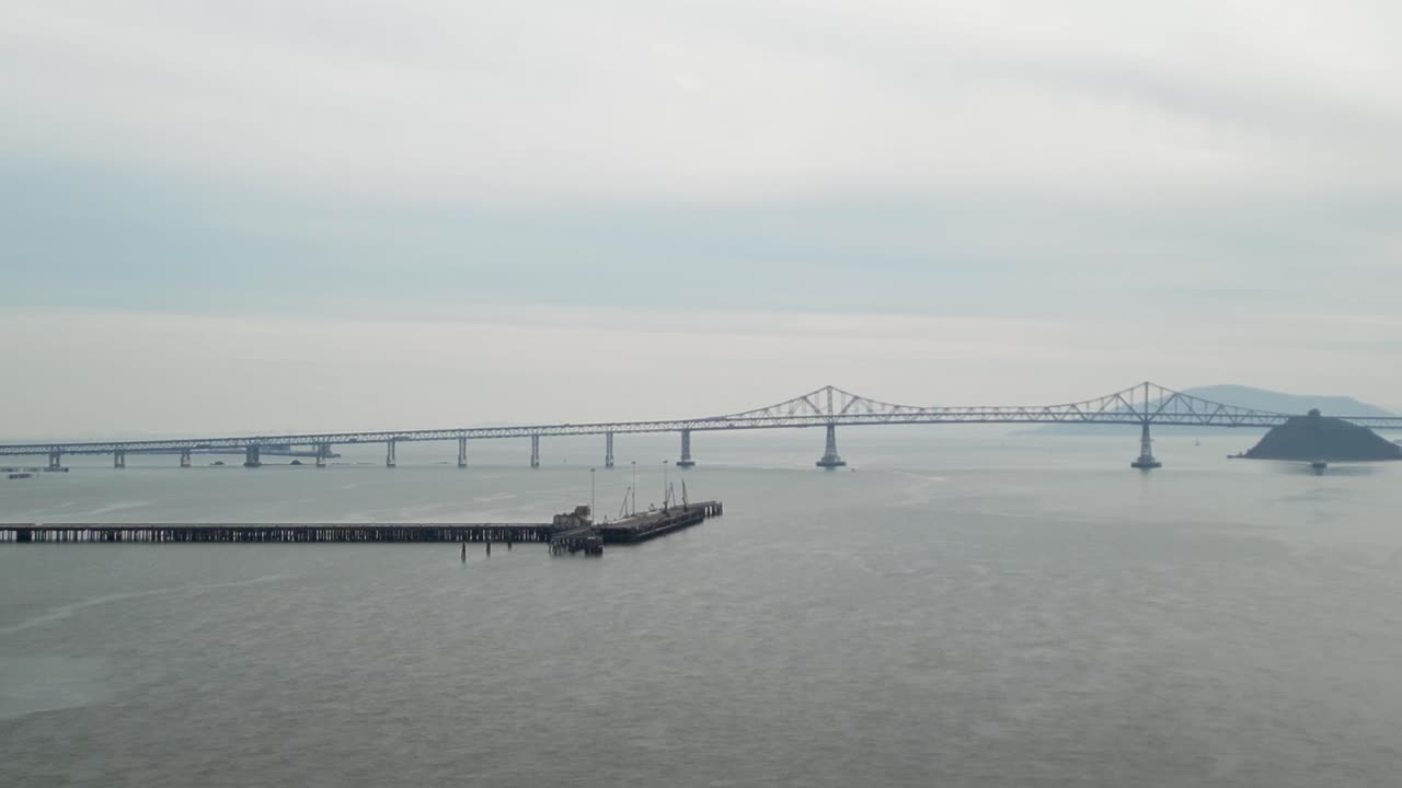 An aerial drone view of the Richmond–San Rafael Bridge from above Point Molate Beach’s coastline.