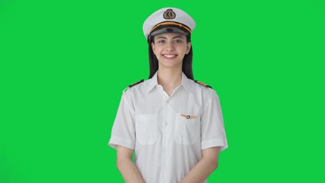 happy indian woman pilot smiling to the camera green screen