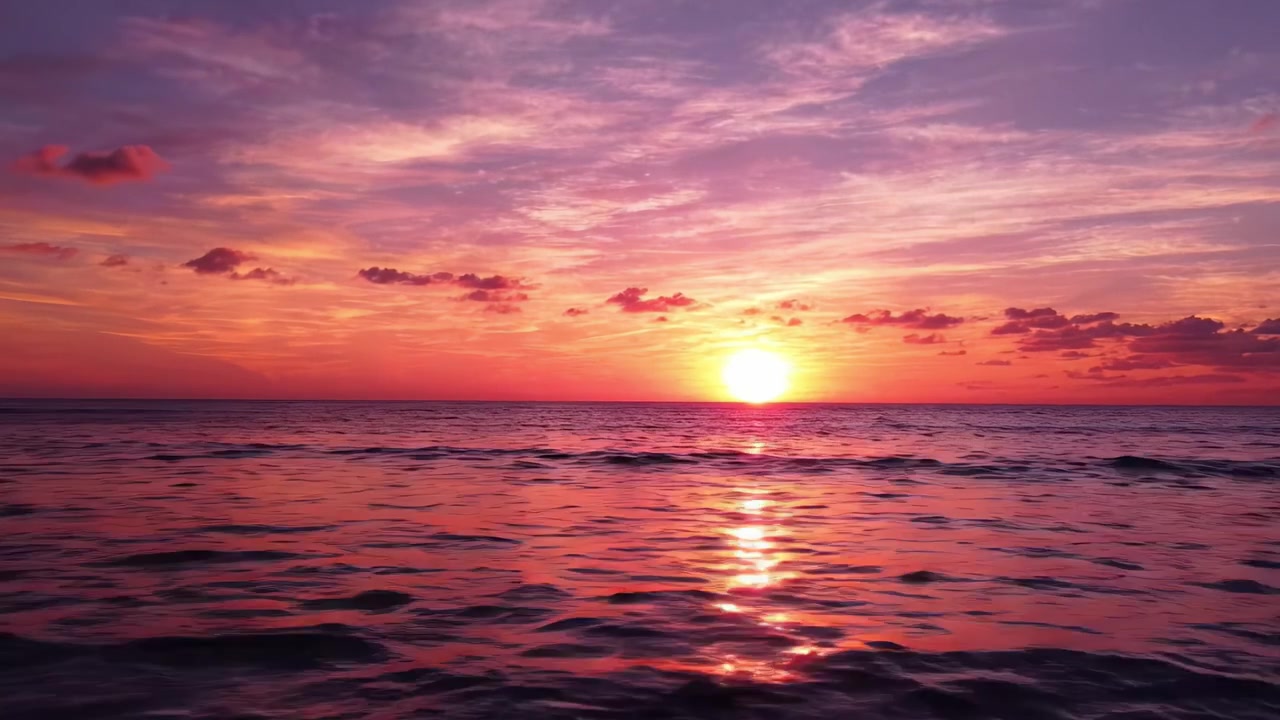A Breathtaking Sunset Over the Ocean, with Vibrant Colors and Reflection on the Water Creating a Serene and Peaceful Atmosphere