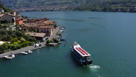 tour boat at monte isola or montisola town on lake iseo in italy