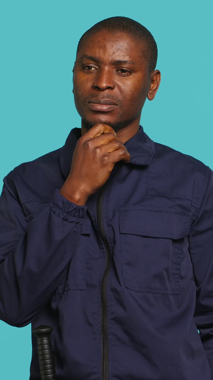 Pensive African American Man Contemplating on Blue Background
