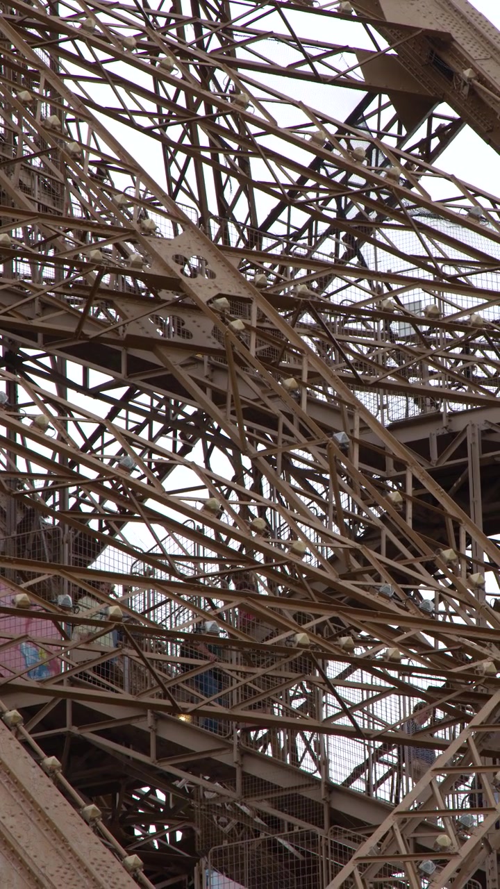 A low angle close-up shot reveals the complex metal engineering and architectural patterns in Paris