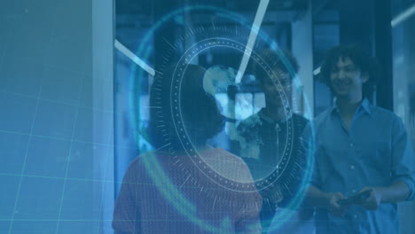 digital globe and data interface animation over people walking in modern office