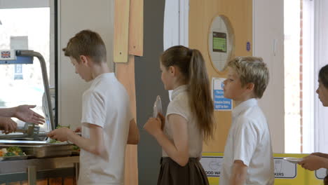 school pupils being served lunch in canteen shot on r3d