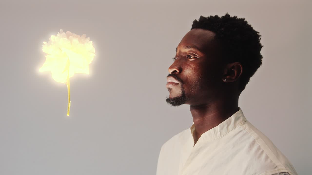 Mesmerized Man Watching Glowing Flower Flying in the Air