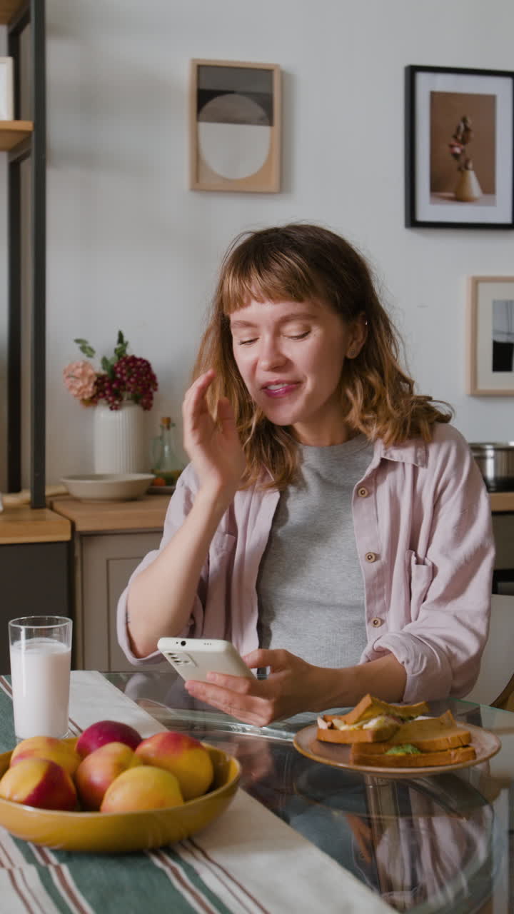 A woman sitting at a table with food and drink