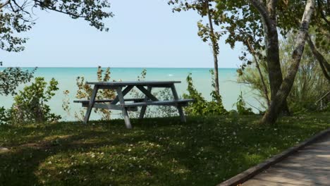 picnic bench overlooking the blue white-capped water of lake huron