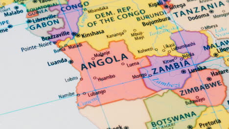 close-up of the country word angola on a world map with the detailed name of the capital city