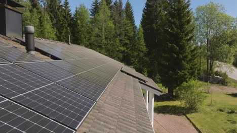 aerial view backwards over pollen covered solar panels on house roof, spring day