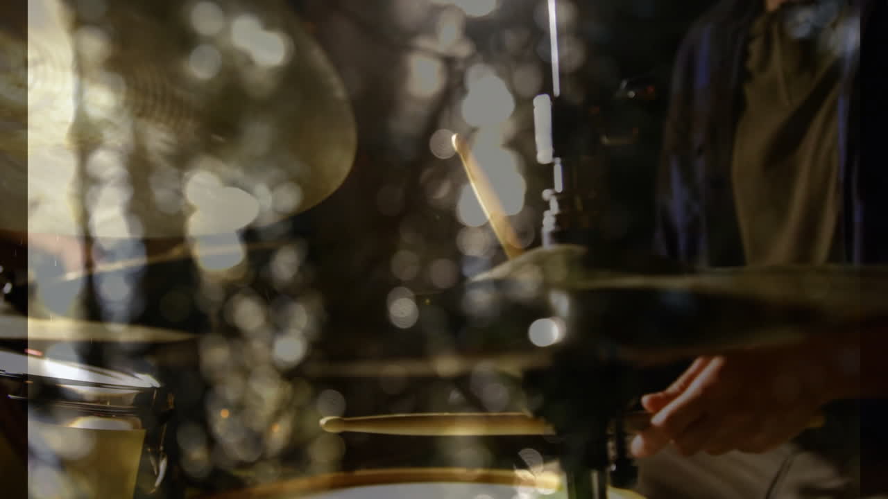 Drummer hand striking cymbal in flat design scene, featuring reflective metal and bokeh lights