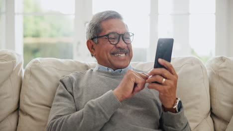 Senior,-happy-man-and-typing-with-phone-in-home