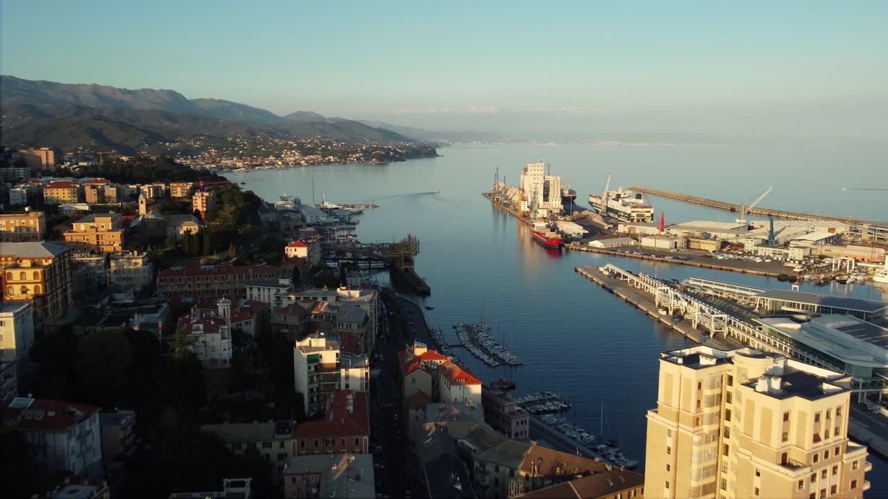 Aerial View of Coastal City with Harbor and Mountains