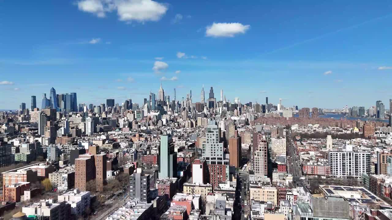Horizontal drone ascending shot over Broome Avenue in New York, capturing the city's vibrant streets, historic architecture, and skyline as the camera smoothly rises.