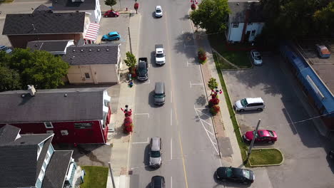 drone shot of traffic on a side street in a beautiful town